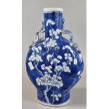 19th century Chinese export porcelain blue and white moon flask, depicting flower and prunus