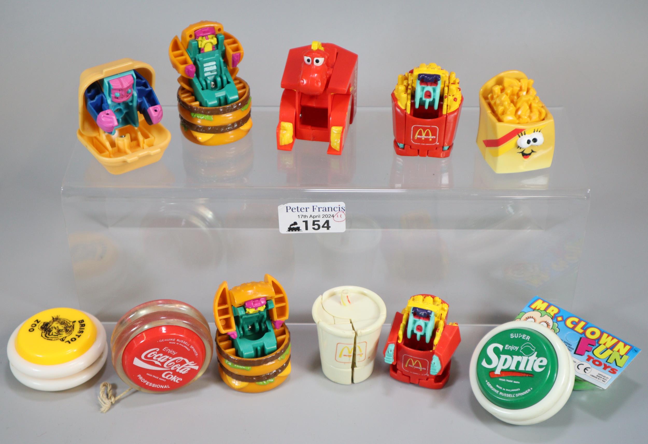 Bag of Mcdonalds Happy Meal Transformer toys together with bag of yoyos to include: Coca Cola,