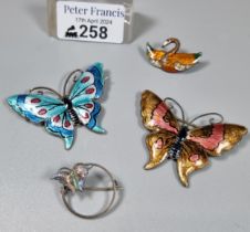 Two silver and enamel brooches in the form of butterflies together with another enamel bird brooch