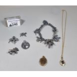 Silver charm bracelet with assorted charms including: poodles, horses etc. together with some