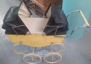 1960s Tri-ang double ended doll's pram with folding canopies and sprung frame. (B.P. 21% + VAT)