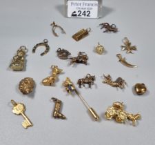 Collection of 9ct gold and other charms to include: horse shoe, race horses, wishbone, dogs, gold