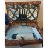 Wicker picnic hamper with accessories together with a modern folding and travelling picnic table. (