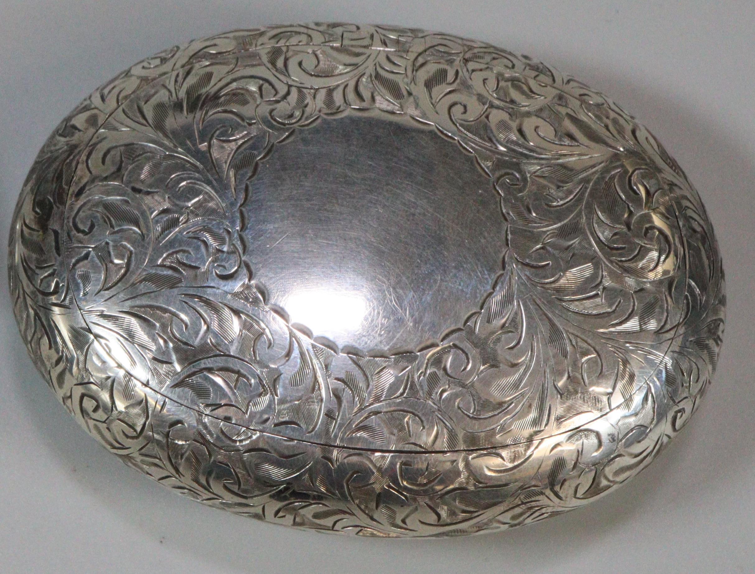 George V silver snuff box with gilt interior, of engraved foliate pebble form. By Henry Williamson