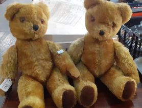 Two similar mid century mohair teddy bears with bells in ears, stitched nose, glass eyes and