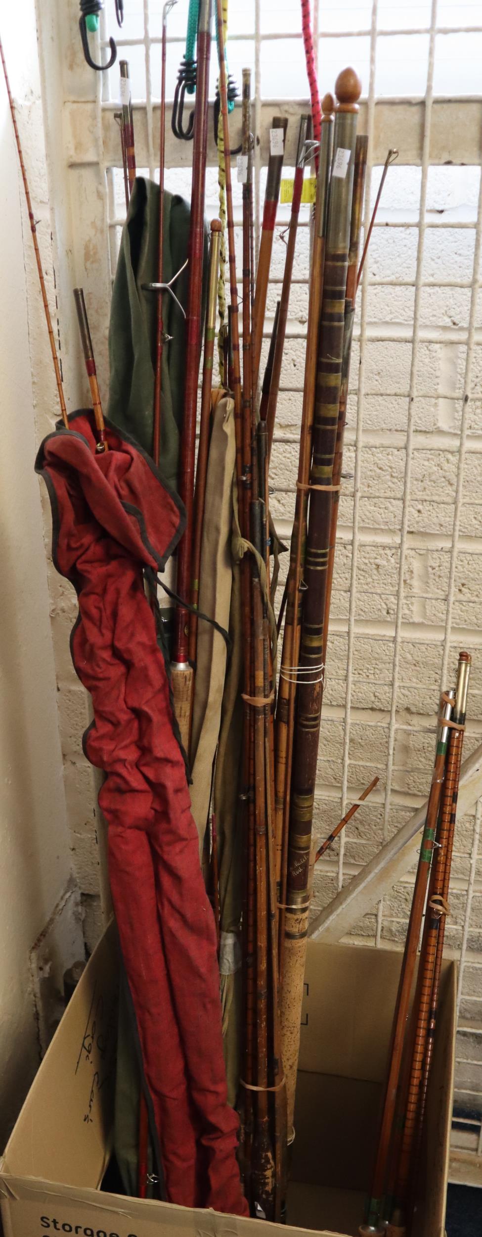 Large collection of assorted Greenheart split cane and other fishing rods, some with canvas cases,