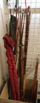 Large collection of assorted Greenheart split cane and other fishing rods, some with canvas cases,
