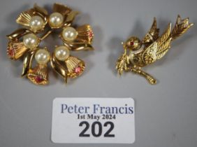 Yellow metal brooch in the form, of a bird together with another gold finish floral and pearl design