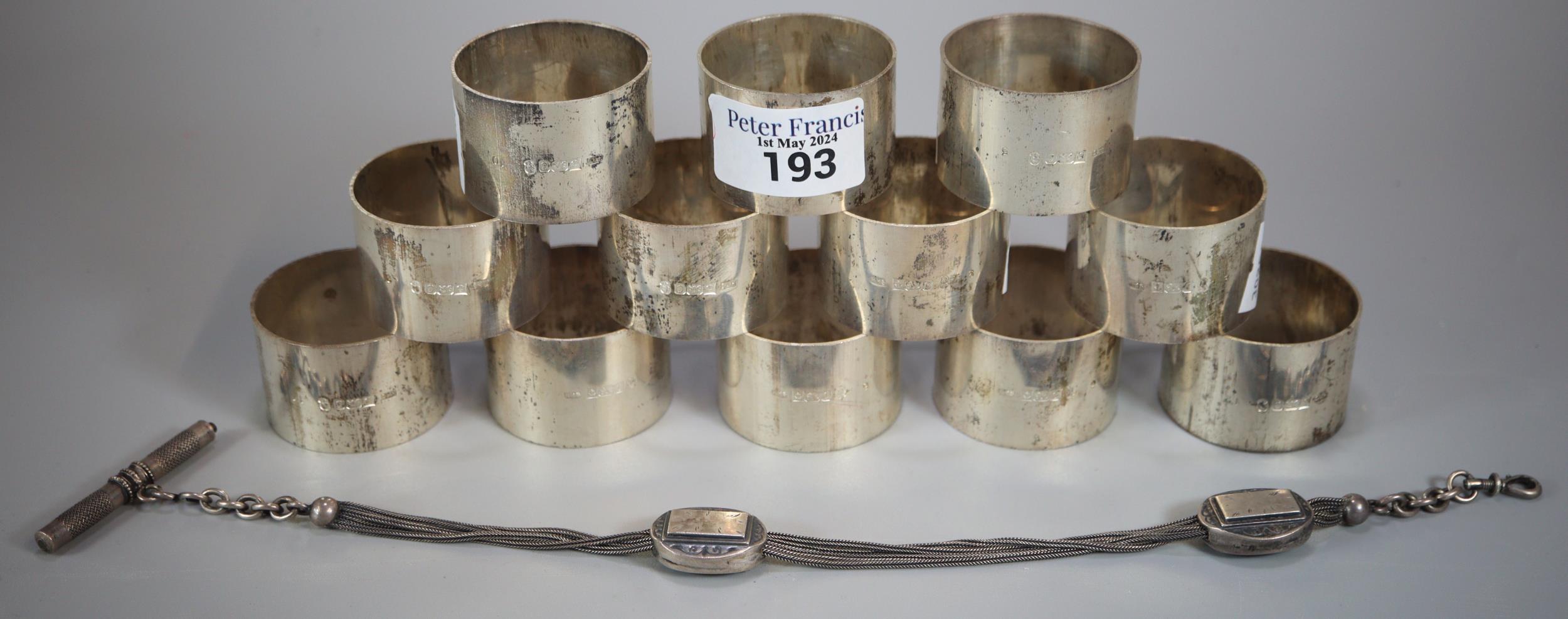 Set of twelve Queen Elizabeth II silver napkin rings. 14 troy oz approx., together with a