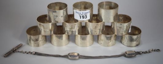 Set of twelve Queen Elizabeth II silver napkin rings. 14 troy oz approx., together with a