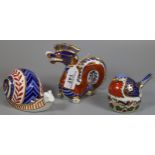 Three Royal Crown Derby English bone china paperweights; 'Robin Nesting' with silver stopper and two