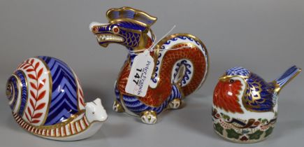 Three Royal Crown Derby English bone china paperweights; 'Robin Nesting' with silver stopper and two