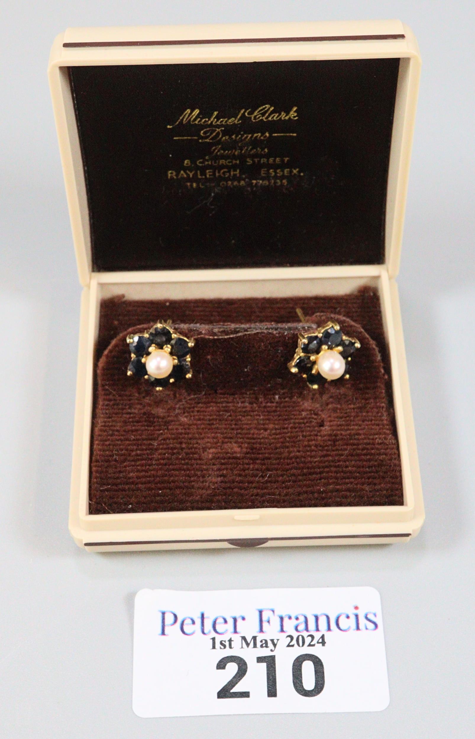 Pair of 9ct gold pearl and sapphire flowerhead rings. 2.6g approx. (B.P. 21% + VAT)