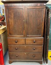19th century oak two stage press cupboard, the moulded cornice above two blind panelled doors, the