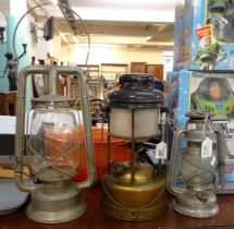 Three vintage lanterns/lamps to include; a Deitz Monarch hurricane lamp, a tilly lamp and a small