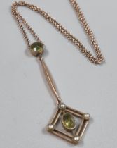 Edwardian 9ct gold peridot and seed pearl pendant on fine link chain. 2.8g approx. (B.P. 21% + VAT)