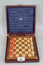 Jaques of London travelling chess set, the pieces in red stained and ivory coloured plastic with a