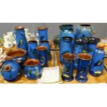 Two trays of Torquay pottery blue ground kingfisher design items; vases, cylinder jugs, pots etc,