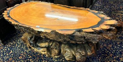 Petrified wood coffee table of oval and rustic form. Length 140cm approx. (B.P. 21% + VAT)