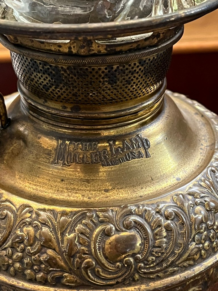 Early 20th century oil burner lamp having green and clear glass shade above a brass repoussé - Image 2 of 4