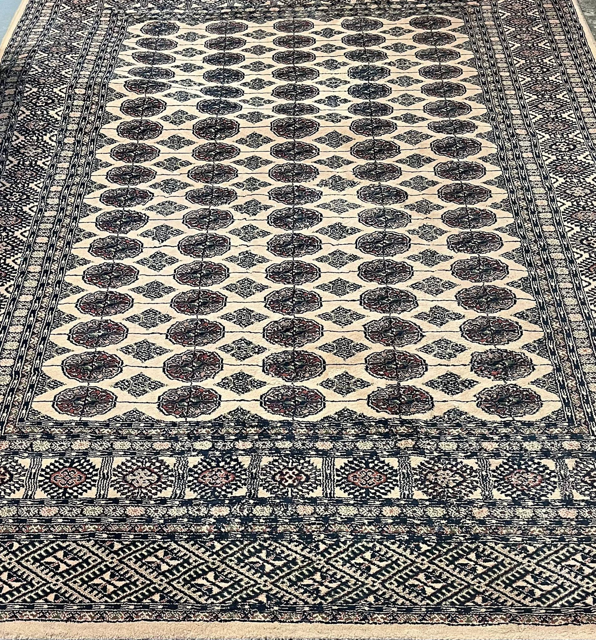 Middle Eastern design, probably Pakistan, beige ground Bokhara rug. 160x227cm approx. (B.P. 21% +