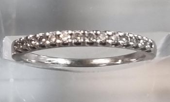 Modern platinum and diamond half eternity ring marked 'Pravins', in Pravins ring box. 1.6g approx.