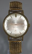 Yellow metal gentleman's wristwatch with satin face having seconds dial on a gold