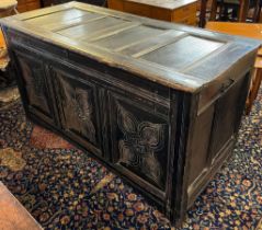 18th century stained oak coffer, the hinged moulded top above three foliate panels on associate