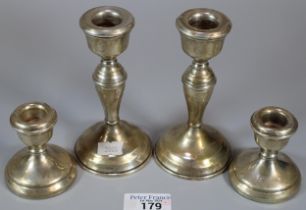 Pair of silver baluster candle sticks together with a pair of silver dwarf candlesticks. Both with