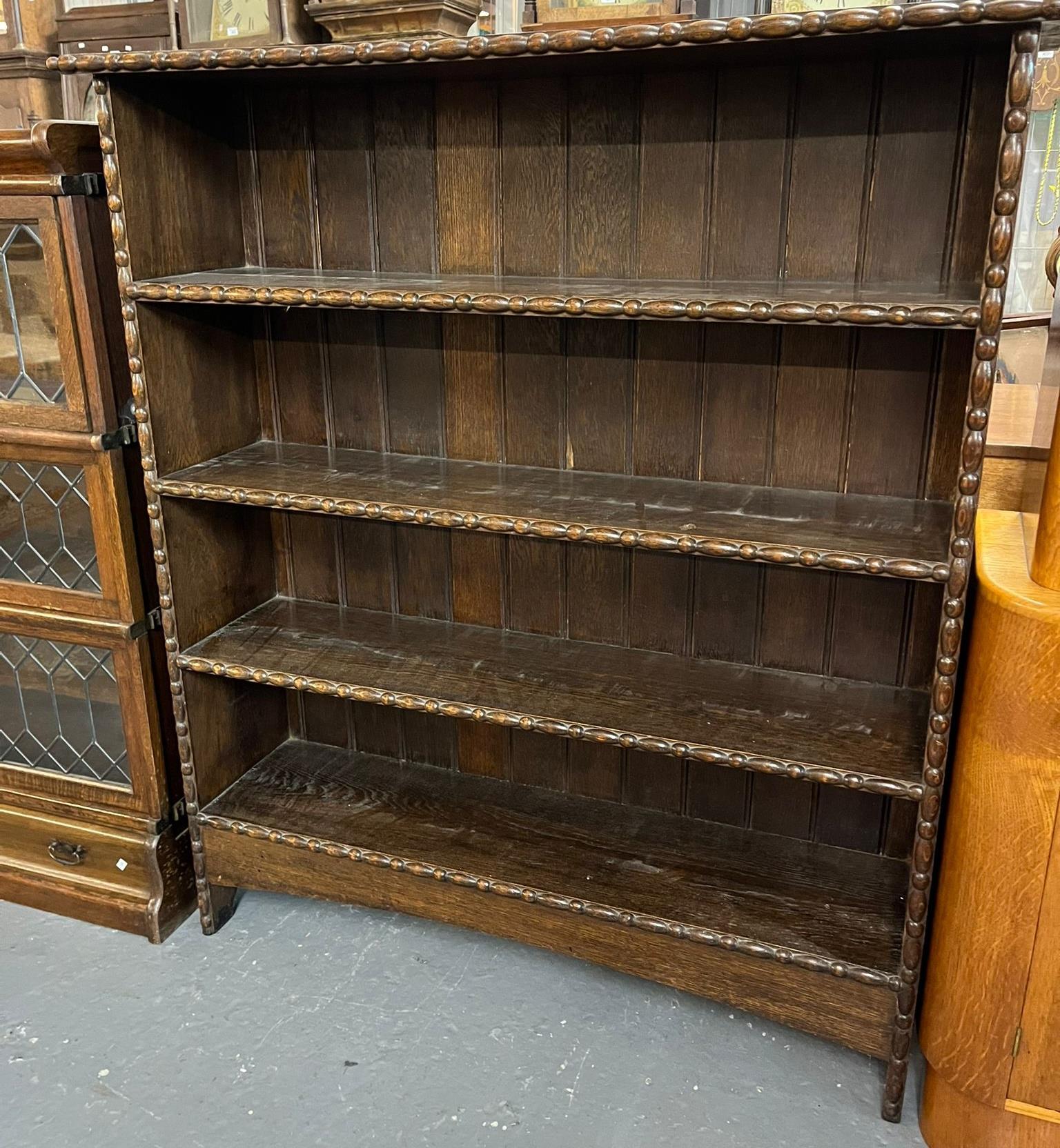 Early 20th century oak free standing open bookcase with moulded designs. 108x28x122cm approx. (B.