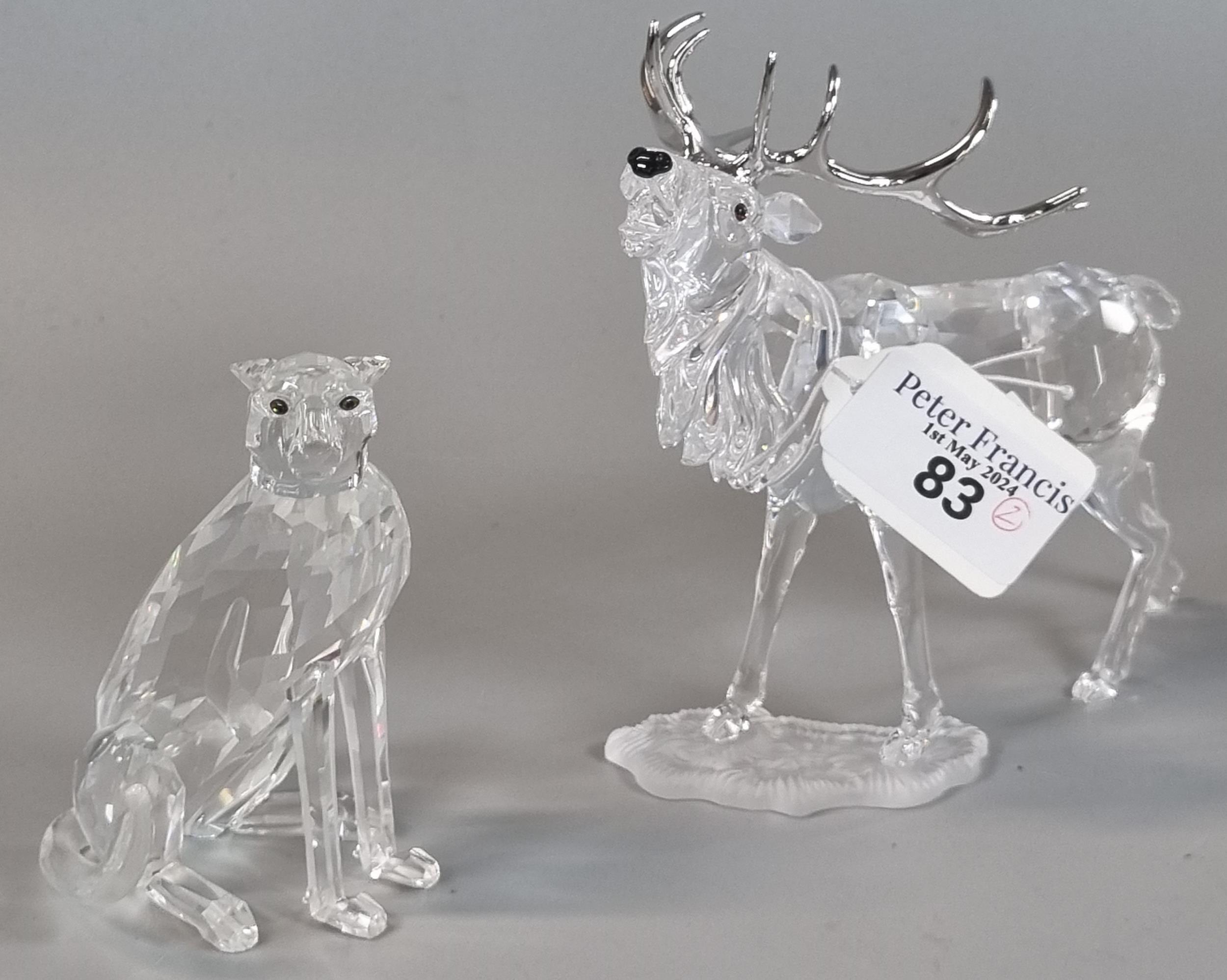 Two Swarovski Crystal animals to include: seated cheetah and stag, both in original boxes. (B.P. 21%