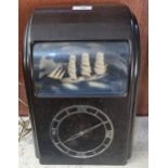 Mid century brown Bakelite Vitascope Industries Ltd electric automaton clock with rocking three