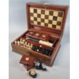 Early 20th century mahogany games compendium, the box containing various chess pieces, card boxes