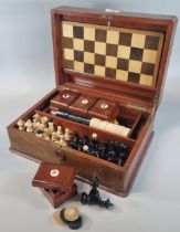 Early 20th century mahogany games compendium, the box containing various chess pieces, card boxes