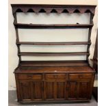 Late 18th early 19th century oak two stage dresser, the moulded cornice above open rack back, the