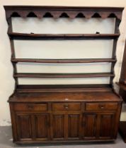 Late 18th early 19th century oak two stage dresser, the moulded cornice above open rack back, the