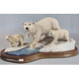 Modern Scottish sculpture of a polar bear with cubs on wooden base, marked to the reverse '