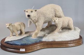 Modern Scottish sculpture of a polar bear with cubs on wooden base, marked to the reverse '