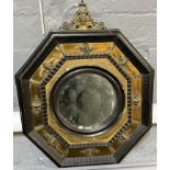 18th century octagonal framed bullseye mirror with gilt metal mounts. 34cm wide approx. (B.P.
