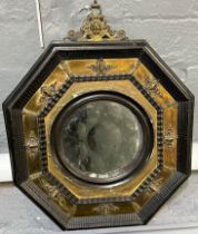 18th century octagonal framed bullseye mirror with gilt metal mounts. 34cm wide approx. (B.P.