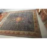 Large Persian style Axminster type carpet with dark blue field, birds, animals and foliage.