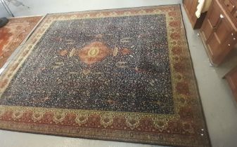 Large Persian style Axminster type carpet with dark blue field, birds, animals and foliage.