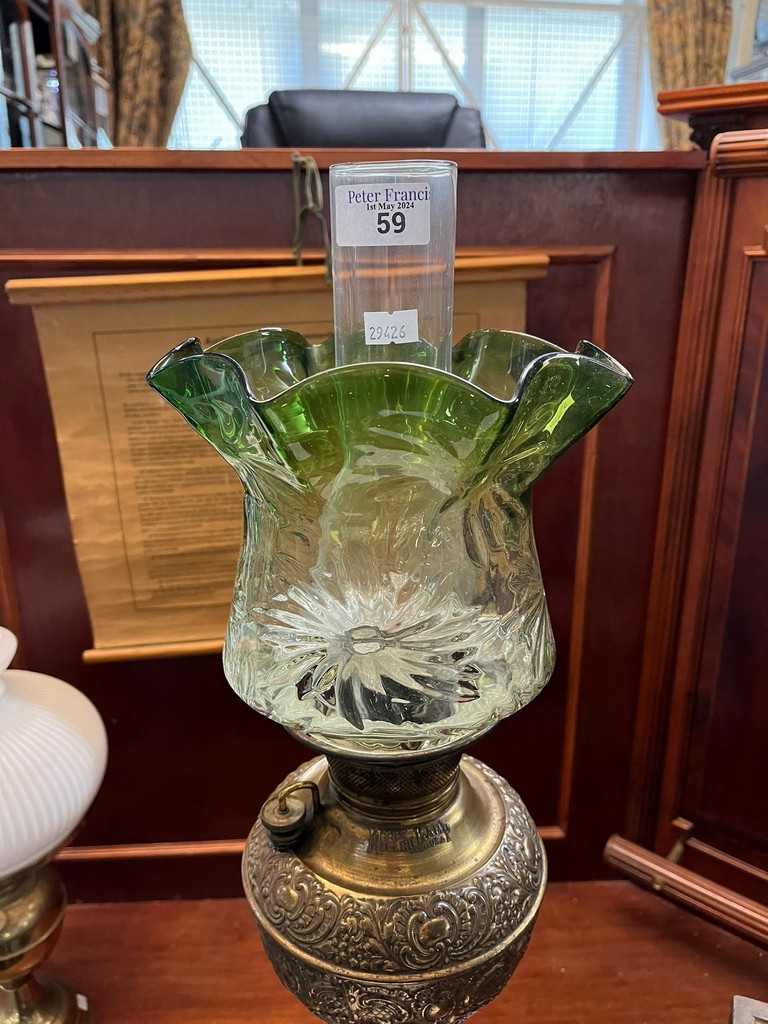 Early 20th century oil burner lamp having green and clear glass shade above a brass repoussé - Image 4 of 4
