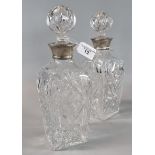 Pair of cut glass square section decanters and stoppers with silver collars. (2) (B.P. 21% + VAT)