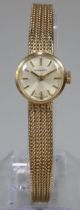 9ct gold Garrard ladies bracelet watch with satin face, having Baton numerals and integral mesh