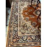 Large traditional design machine made orange ground carpet with overall foliate decoration.