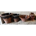 Three terracotta dairy pans/pots together with a terracotta single handled baluster jug. (4) (B.P.