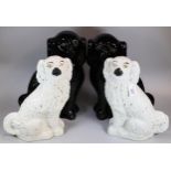 Two pairs of Staffordshire pottery seated fireside Spaniels; one black pair with glass eyes. (4) (