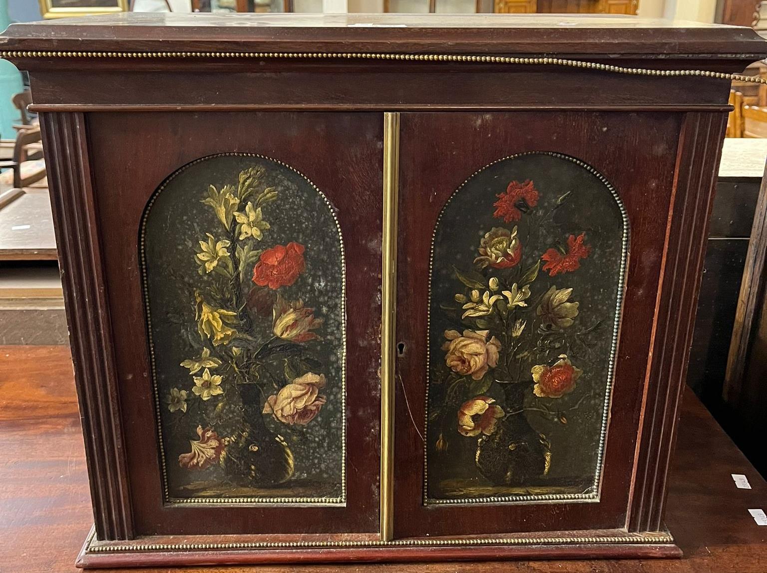 19th century mahogany table top two door collector's cabinet with painted panels of flowers and