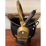 Brass helmet shaped coal scuttle with swing handle and shovel. (B.P. 21% + VAT)